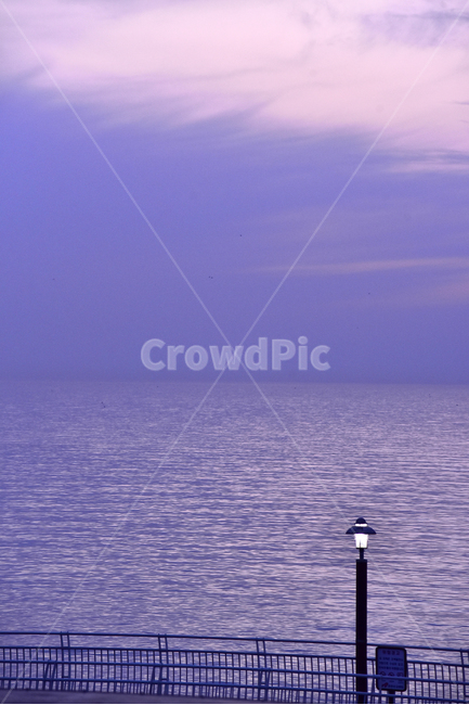 evening scenery,atmosphere,lamplight,color,blue tone,dusk,sea,At sunset,blue sea,guardrail,quiet,security light,guide light,sensible,sky,emotional,feeling,water,Emotional photo,outdoor,ocean,blue,outdoors,background,deserted,nightfall,fence,Emotional land
