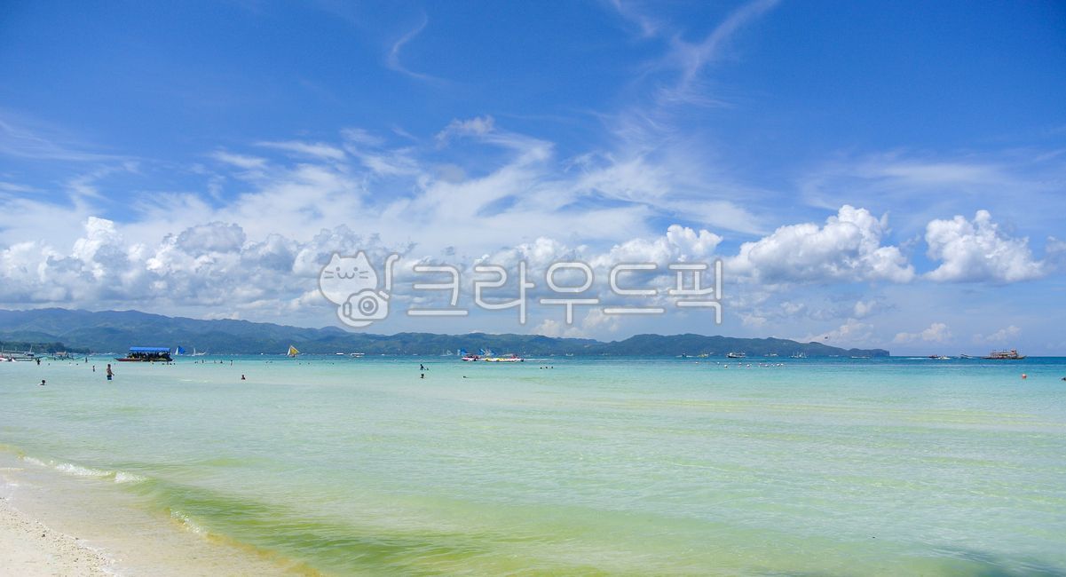 Beach,sea,emerald,indigo,water,sky,clouds,summer,sunshine,vacation,travel,tourism,resort,coastline,landscape,wide angle,panorama,mountain,island,boat,people,swimming,leisure,relaxation,vibrant,nature,clear,beautiful,exotic,out