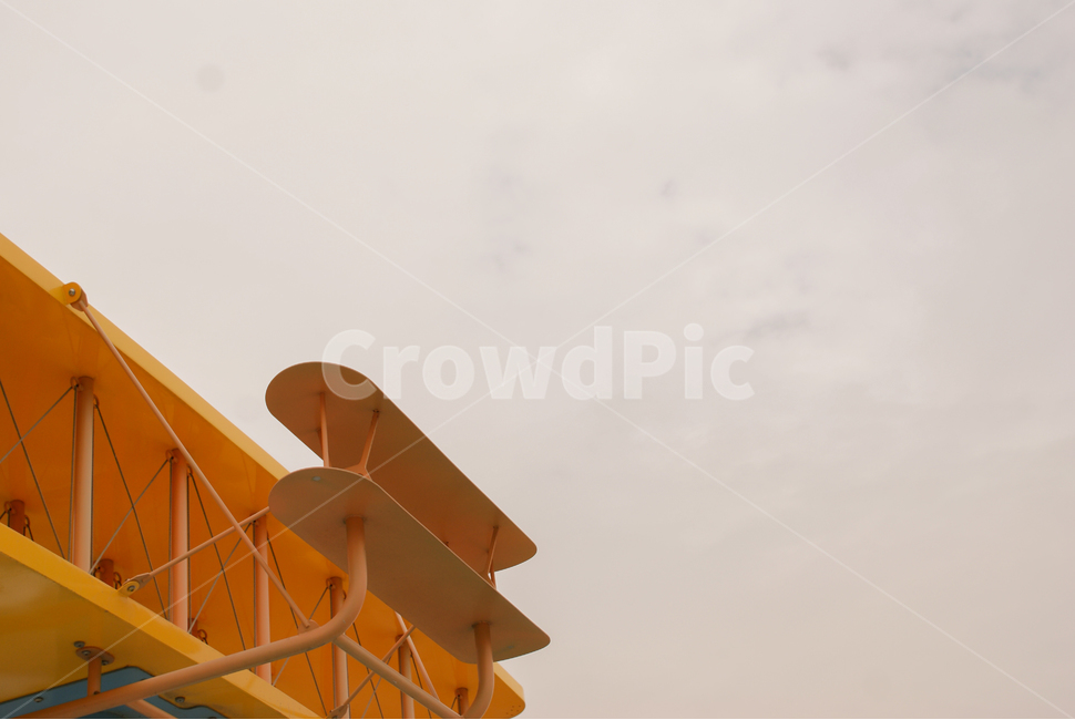 installation art,propeller,empty place,airplane,yellow,model,cloudy day,toy