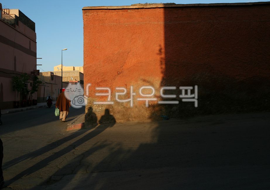 light and shadow,red wall,city,person,sunset,late afternoon,human