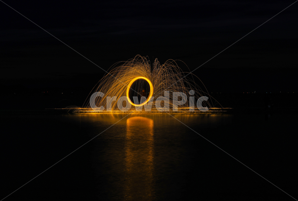 night view,reflection,steal,iron core,rotation,fireworks,water,horoscope,ocean,sight,flame,iron core flame,Fireworks