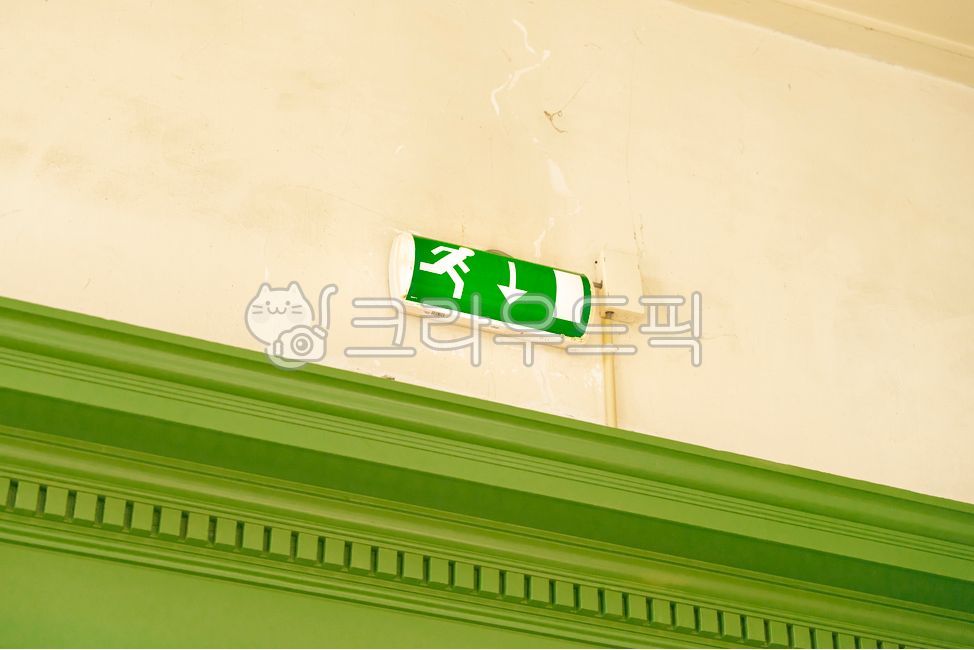 Exit sign,emergency exit,green,wall,arrow,running person,safety,building,interior,molding,painted wall,emergency,fire safety,down arrow,security,escape route,exit,passage,protection,evacuation,danger,safety regulations,prevention,gu
