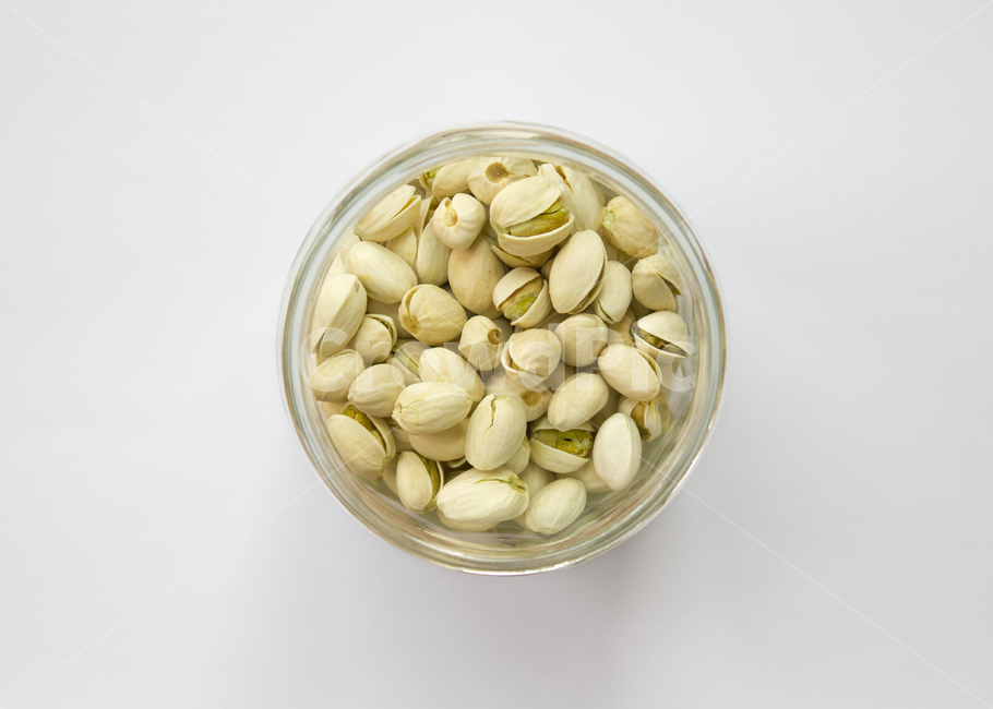 legumes,several,white background,bottle,nut,top angle,top,hard,bean,pistachio,glass,top view,superfood,glass bottle,health,dry,circular,many,food,contained,nuts,closeup,circle