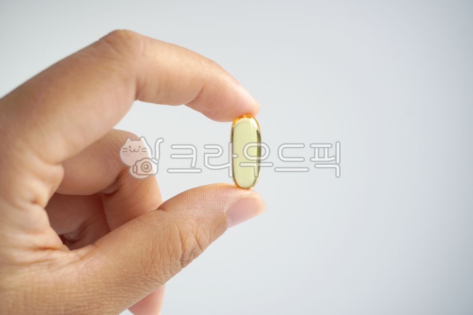 capsule,yellow,pill,transparent,Omega 3,Nutrients,hand,finger,pinch,soft capsule,health,medicine,omega3,omega,health supplements,Medicine,supplements,approximately,pharmacy