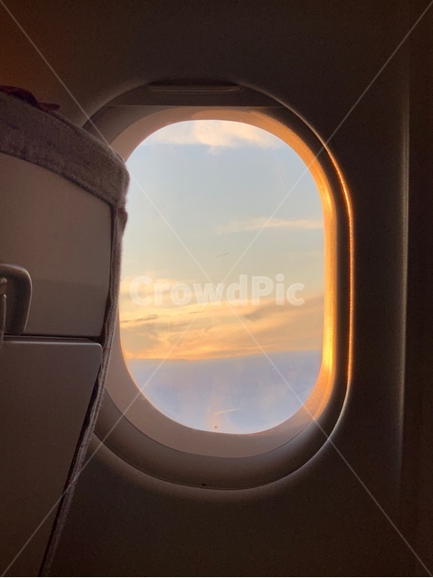 sky,airplane window,airplane,sunset,sunset outside the window,sunset sky,window,Inside the plane