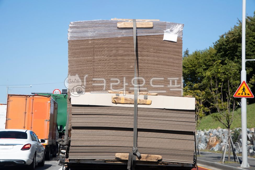 container,Transportation,freight,truck,road sign,industry,transport,overload,outdoor,automobile,bar,crosswalk,paper,road,safety,colonnade,road name,cardboard,traffic