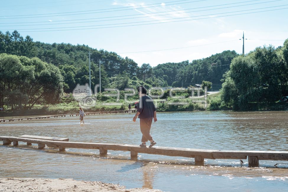 woman,countryside,tourist attraction,Museom Village,one person,traditional bridge,single wooden bridge,wooden bridge,Gyeongsangbukdo,stepping stones,Yeongju,bridge,river