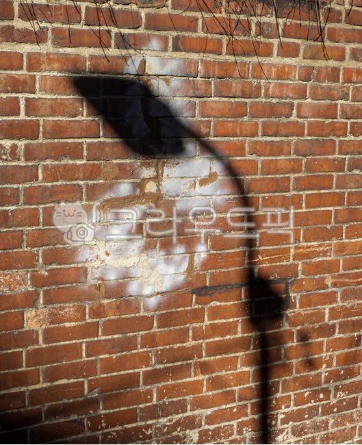 shadow,street lamp shadow,brick,wall