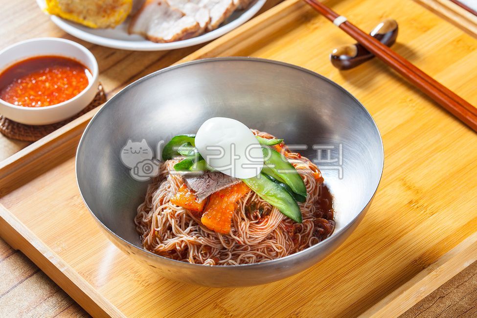 Mulnaengmyeon,tray,egg,cucumber,chopsticks,Bibim Naengmyeon,wooden chopsticks,Traditional menu,beef,bowl,Cold noodles,bamboo tray,Hamheung Naengmyeon,Bibim Naengmyeon Sauce,Meat Cold Noodles,Hoenaengmyeon,watercress,Beef Cold Noodles,Naengmyeonsari,restau
