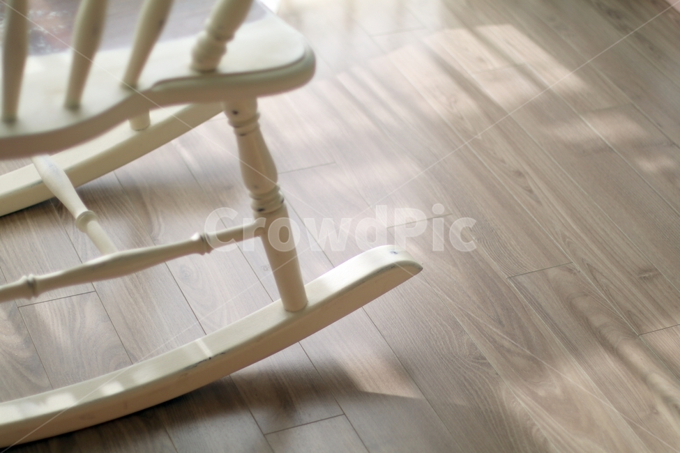 swing chair,sunlight,rocking chair,living room floor,chair,1 chair,living room,hardwood floor,floor