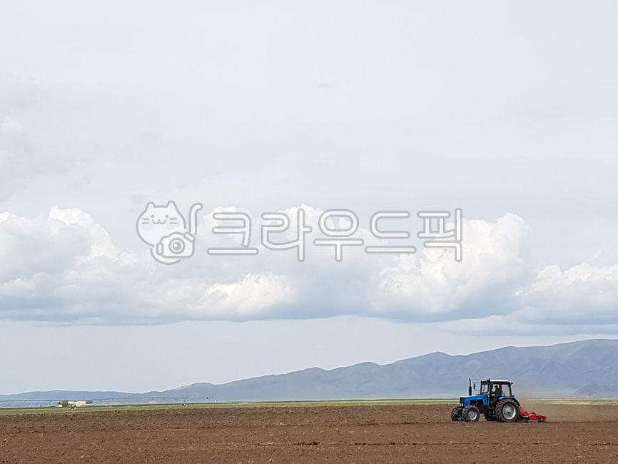 sky,packaging,mountain range,Central Asia,Kazakhstan,tillage,cloud,horizon,mountain,tractor,farming,sight,Agriculture