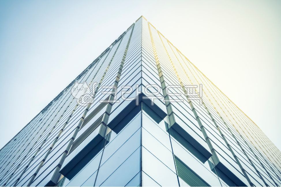 city,construct,building,Modern,corner,office building,high rise building,architecture,tower,business,officebuilding,skyscraper,low angle,highrise,sunlight,outdoors,blue,window