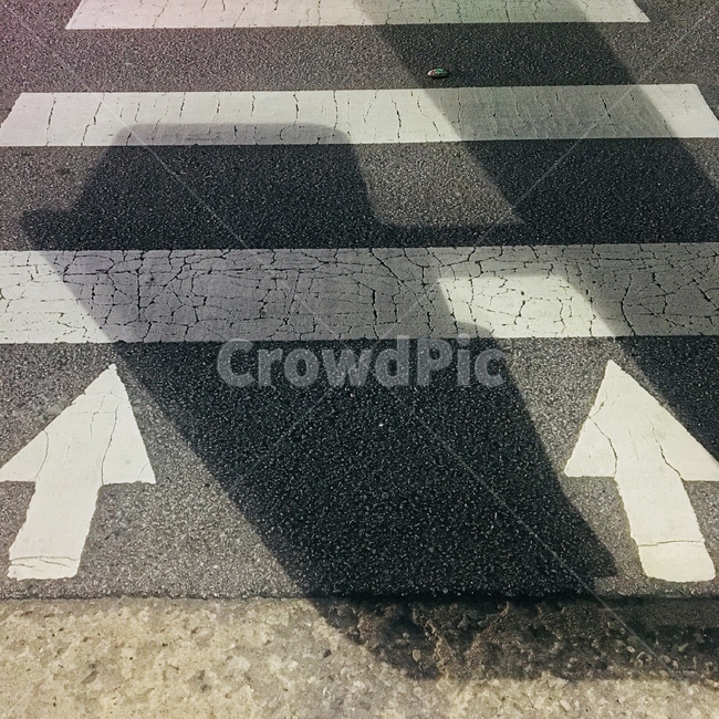 crosswalk,shadow,arrow,road,autumn night,road name,asphalt,dinner,walk