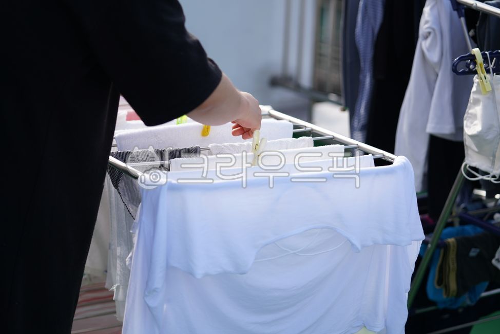 drying rack,housekeeping,clothespins,clothes,drying,laundry,person,clothing,job,housework,human,humans