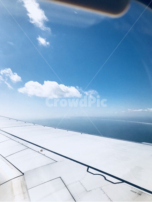 sky,cloud,horizon,sunlight,blue,clear sky,airplane,white clouds,high place,puffy clouds