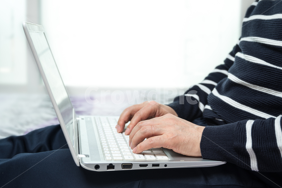 bed,use,industry,laptop,remote,network,computer,search,middle age,freelance,casual,indoors,man,communication,work from home,businessman,hand,digital,business,home office,work,copyspace,wireless internet,mobile,technology,home,closeup,person,40s,typing,50s