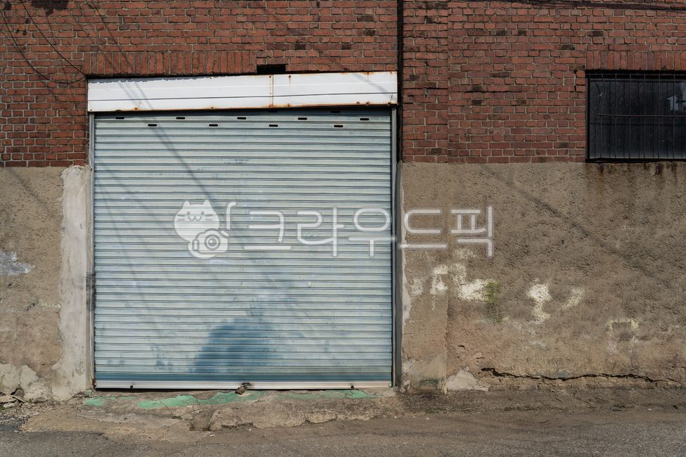 iron door,closed door,old door,rusty iron door,metal door,industrial facility,old structure,abandoned building,rough texture,closed space,architectural element,factory entrance door,iron structure,old exterior,vintage atmosphere