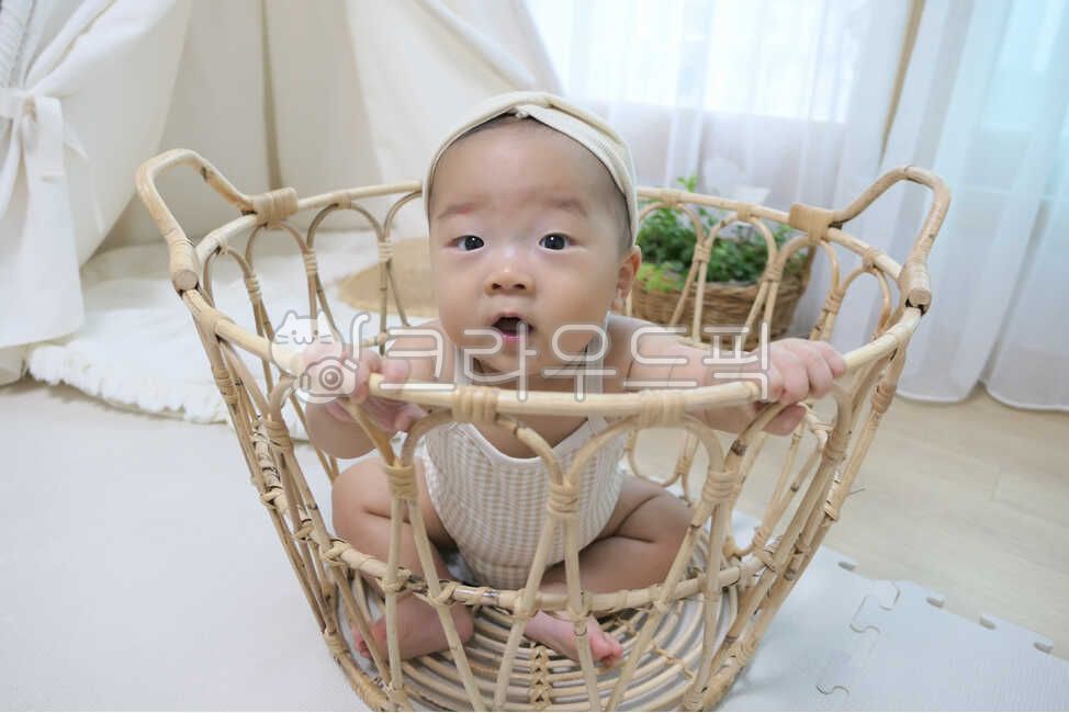baby model,small,tent,facial expression,rattan basket,rug,young,held,playroom,innocent,0 year old,rattan,Basket,mothers arms,infant,pure,cute,one year old,straw hat,life,interior,son,angelic,hat,baby tent,human,parenting,lovely,precious,newborn,1 year old