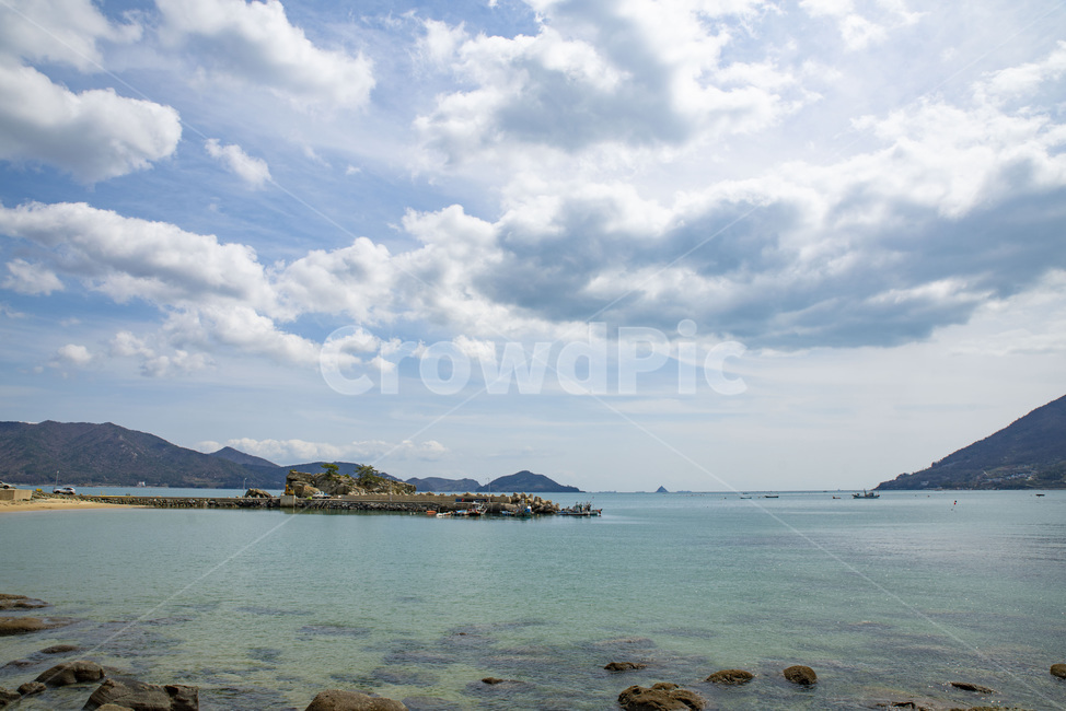 sky,blue sky,country,coastline,nature,island,water,sea,coast,blue sea,ocean,blue,outdoors,shoreline,land,Sunny