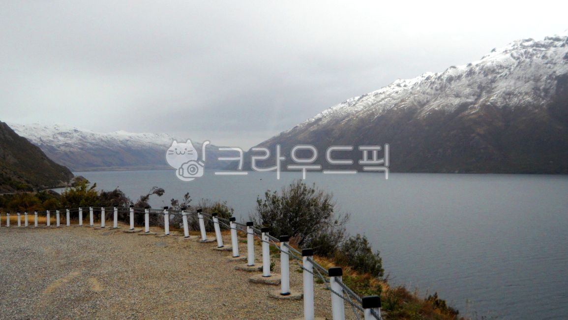 mountainrange,mountainous landforms,clouds,scenery,new zealand,cloud,mountain,mountainouslandforms,grass,railing,land,highland,meadow,sky,handrail,nature,banister,mountain range,water,grassland,outdoor,hill,natural scenery,panorama,outdoors,field,newzeala