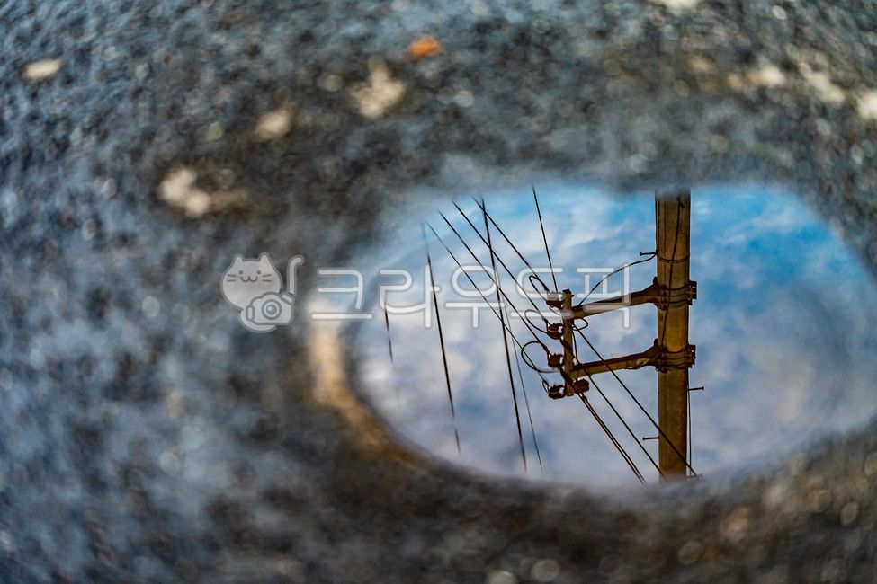 puddle,telegraph cord,Standing water,reflected in the water,pool,telephone pole,blur,asphalt,reflection photo,electric wire