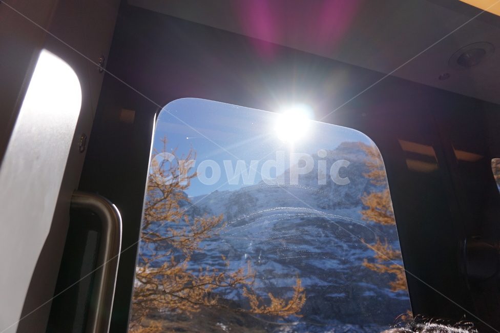 jungfrau,sunshine,view outside the window,ice,scenery,sun,mountain train,glare,mountain,fallen leaves,train,nature,switzerland,tree,handle,snowy mountain,sunlight,outdoors,snow,view outside the train,window,flash
