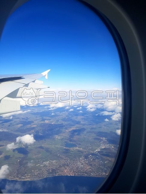 sky,cloud,mountain,window,wing,Inside the plane