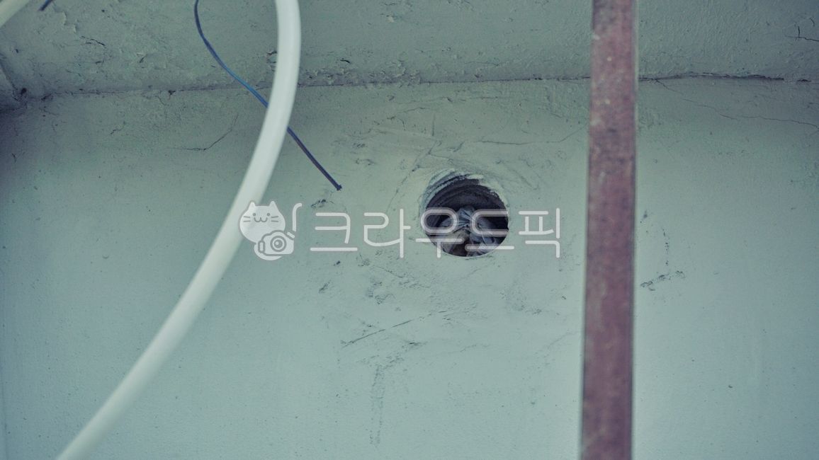 hole,newspaper,boiler hole,gap,wall,hole in the wall