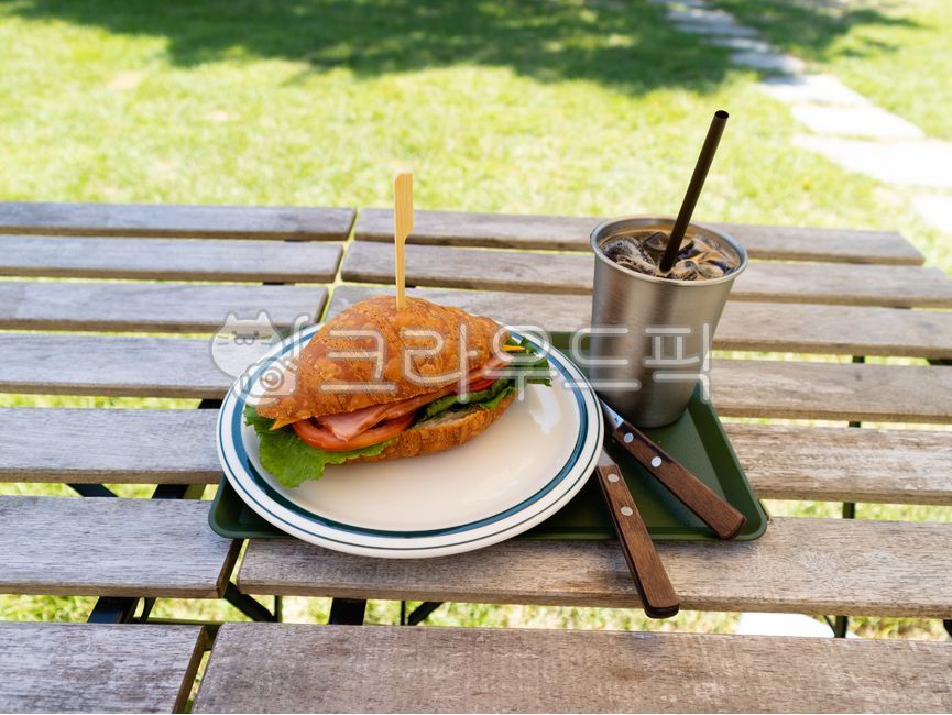 outdoor,bread,cafe,dessert,croissant,sandwich,outdoor table,table,food,iced coffee