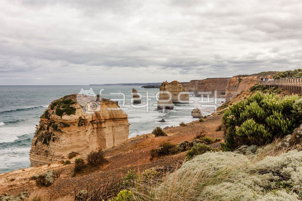 Great Ocean Road,12 Apostles,Mother Nature,Sea,Cliff,Rock,Pillar,Stone Tower,Wave,Coast,Beach,Dark Cloud,Cloudy,Limestone,Australia,Tourist Attraction,Erosion,Cliff,Precipice,Horizon,Geology,Magnificent,Majestic,Atmosphere