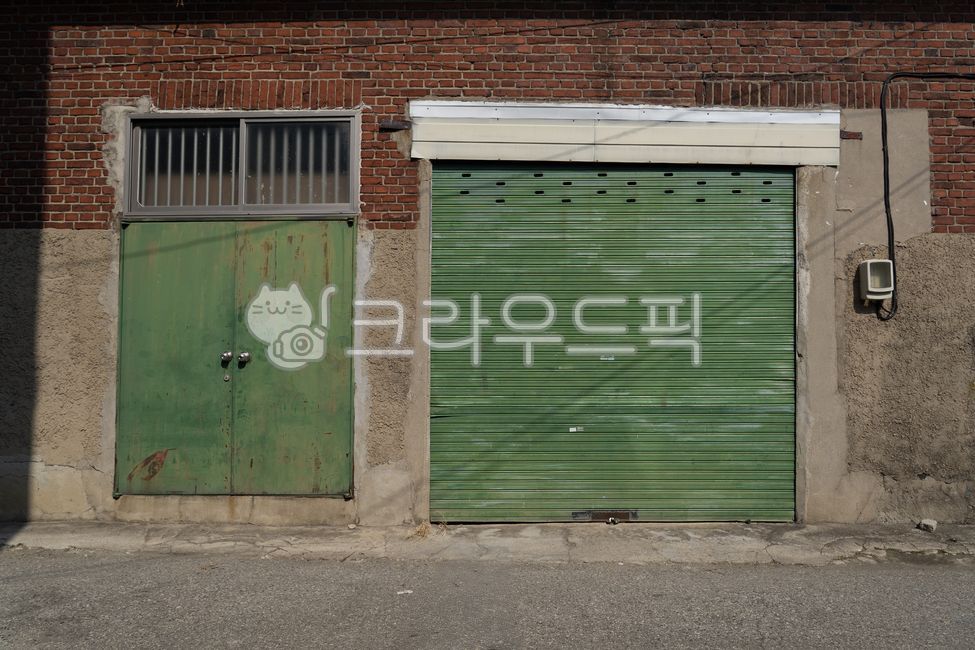 iron door,closed door,old door,rusty iron door,metal door,industrial facility,old structure,abandoned building,rough texture,closed space,architectural element,factory entrance door,iron structure,old exterior,vintage atmosphere