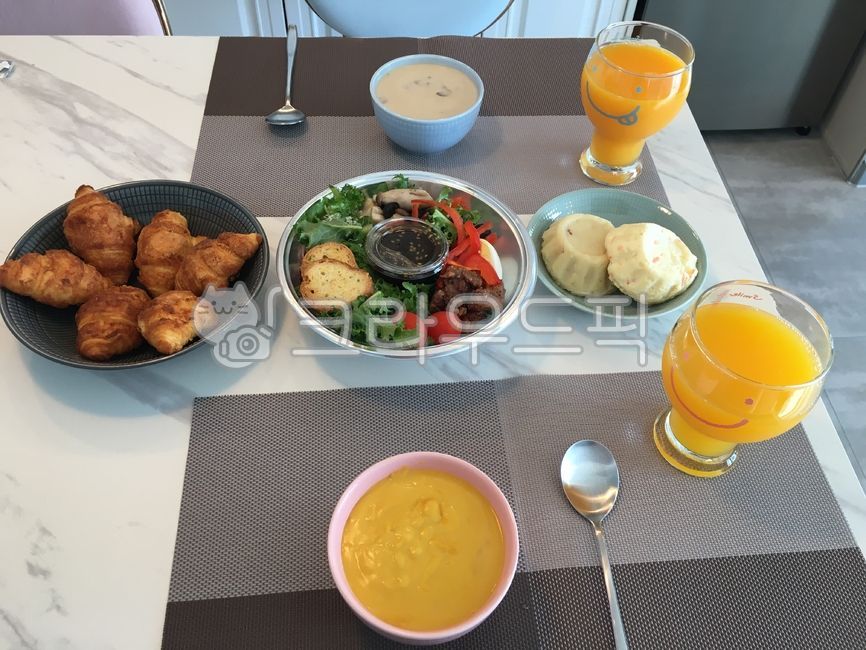 pumpkin soup,bread,salad,Orange juice,Citrus Juice,brunch,Spoon,yellow,croissant,mushroom soup