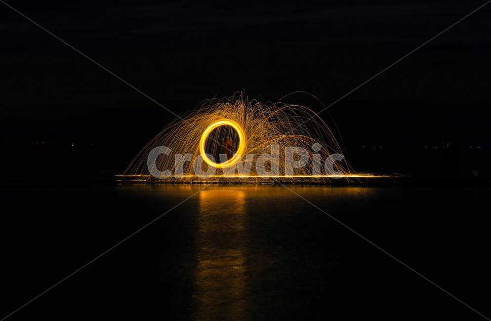 night view,reflection,steal,iron core,rotation,fireworks,water,horoscope,ocean,sight,flame,iron core flame,Fireworks