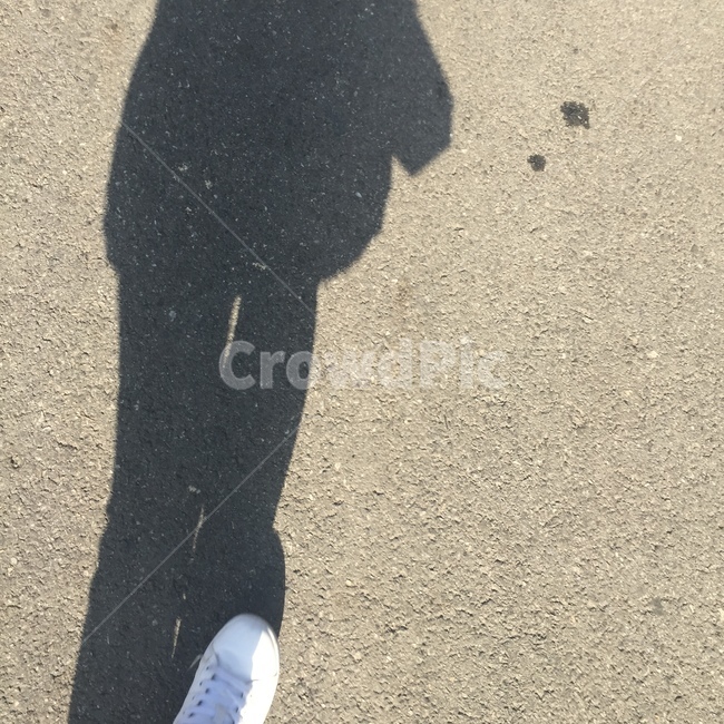 human shadow,shadow,running shoes,asphalt,Emotion