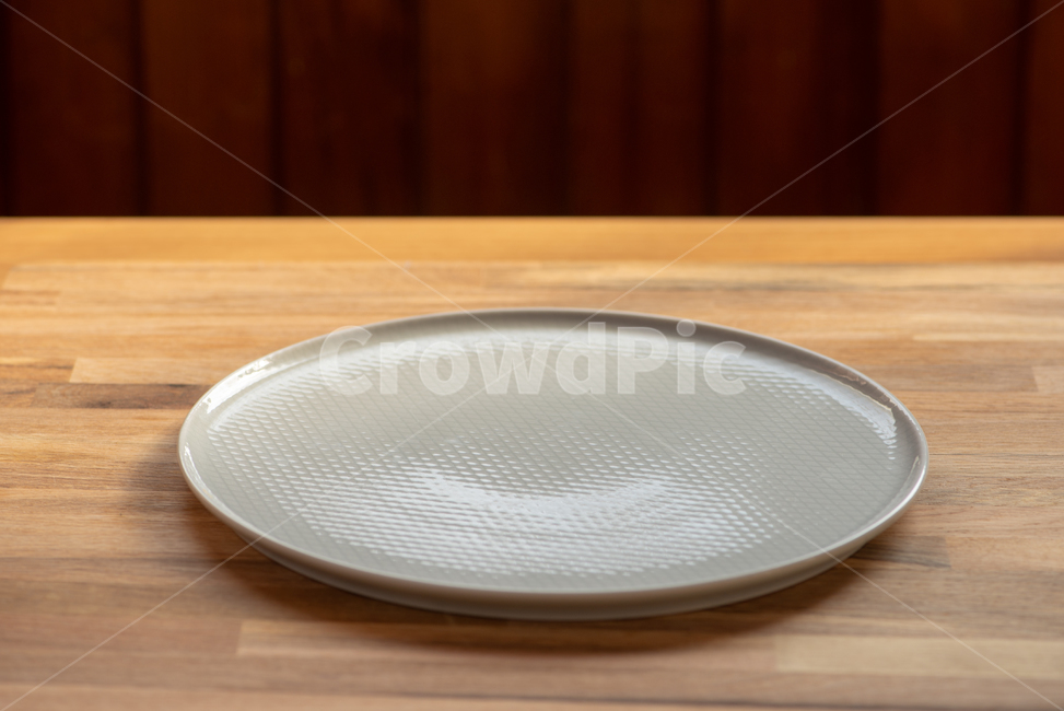 empty plate,wooden table,prop,plate,low angle,empty bowl,bowl,wooden cutting board