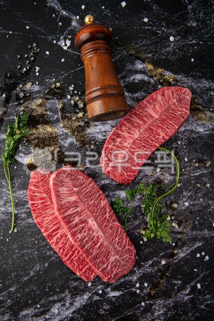 raw meat,beef,ribeye,steak,olive oil,sirloin,ribeye,garnish,meat,salt,Korean beef,knife,vintage,dark,food,meal,food,special cut,top view,staged cut,pepper,studio shot,fresh,bright red