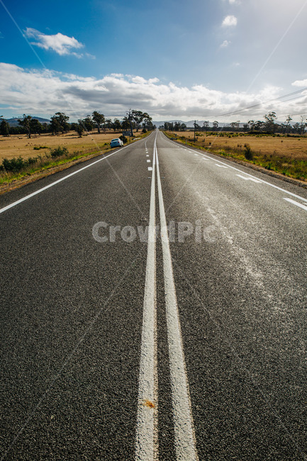 blue sky,extended road,hot,long,cloud,see,road,floor,lane,sky,sidewalk,tasmania,straight road,Tasmania,center,tree,clear,australia,asphalt,low cloud,clear day,straight,hill,driveway,Australia,car road,carroad