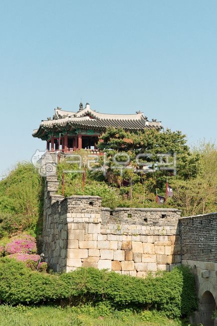 fortress,stone,wall,pavilion,flag,roof,flower,plant,spring,traditional,architecture,heritage,history,tourism,tower,column,stairs,green,nature,building