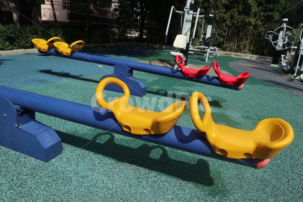 playground floor,yellow seesaw,red seesaw,playground,seesaw