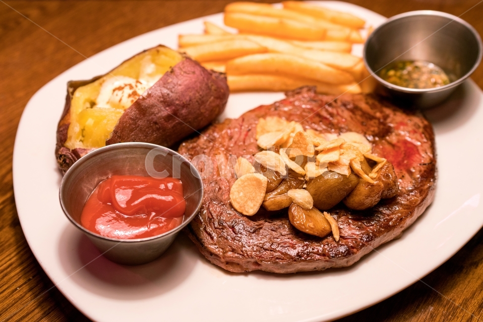 sweet potato,steak,beef,plate,sauce,potato,frenchfries,garlic fries,garlic,restaurant,Steak,rice,sweetpotato,meal,whole potato,French fries,dish,meat,gravy,whole sweet potato,western,western food,ketchup