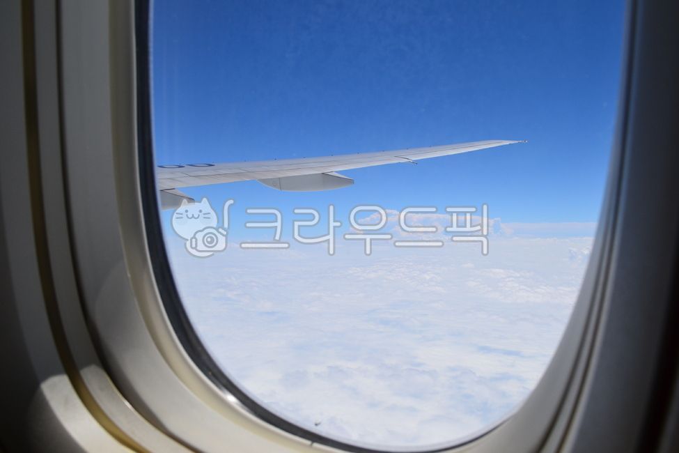 sky above clouds,outside the plane,airplane,above the clouds,window